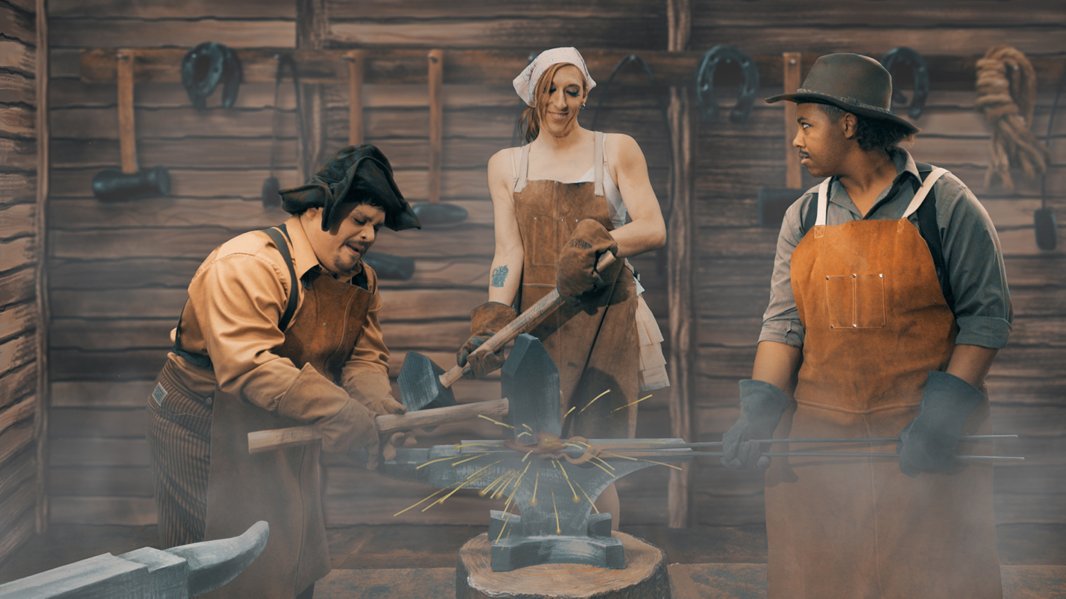 Video still showing three blacksmiths against a cartoonist background