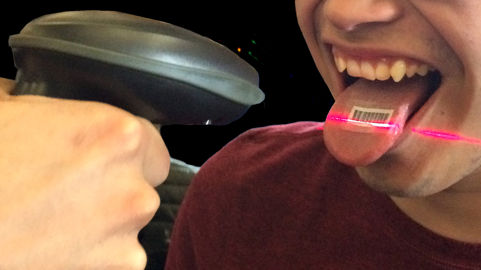 Photograph of a barcode scanner scanning a barcode on a person's tongue.