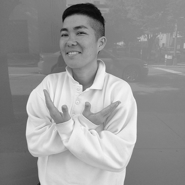 Black and white photograph of a person with their arms crossed