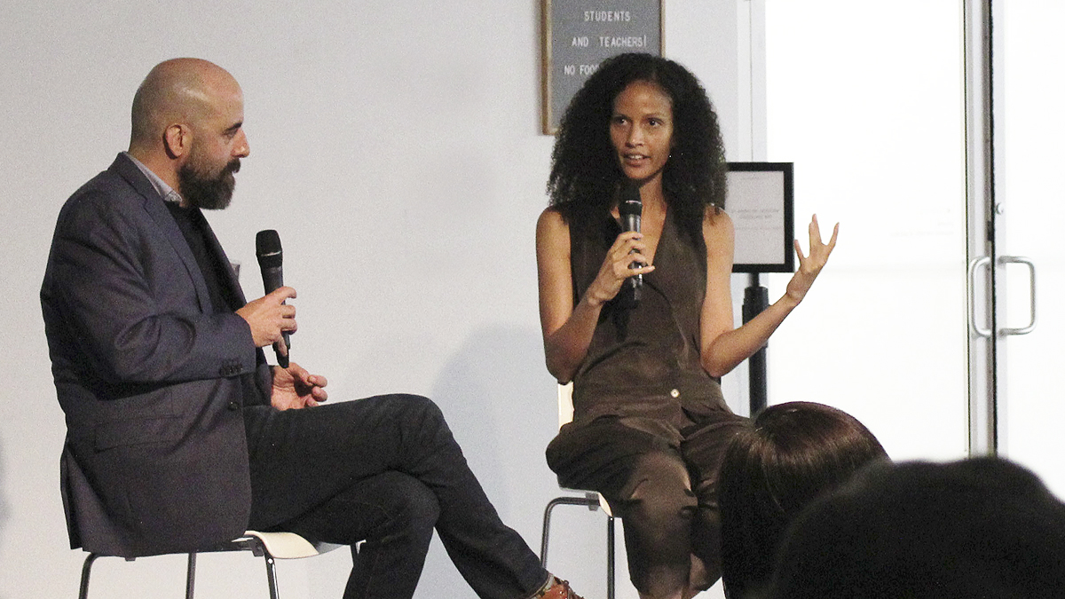 Two people having a conversation in front of an audience