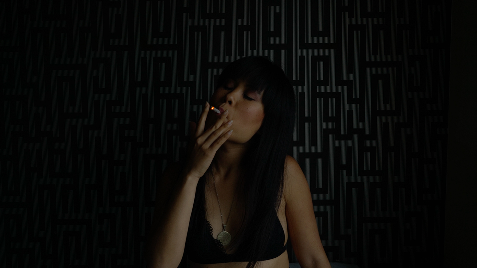 Woman smoking in a dark room