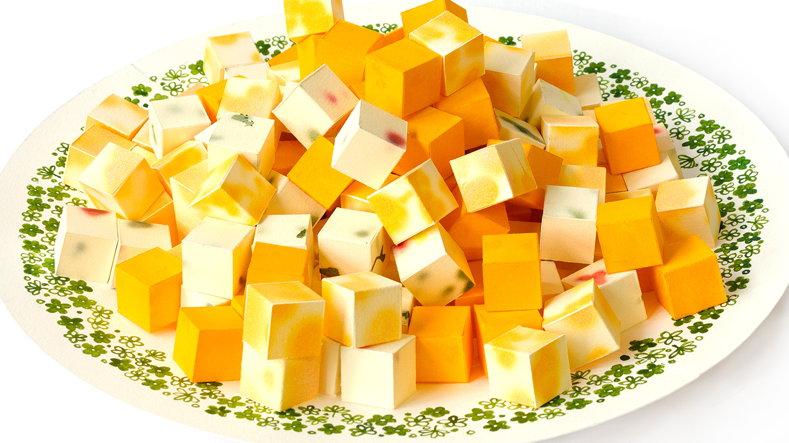 A plate of cheese cubes all made from paper