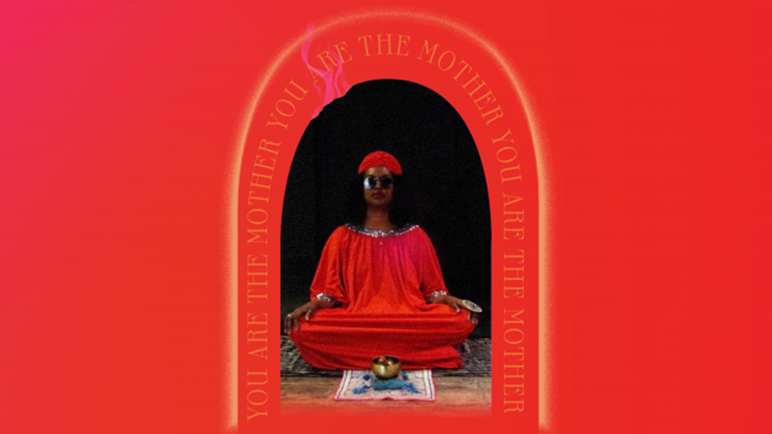 Person sitting in a mediation pose with a red background