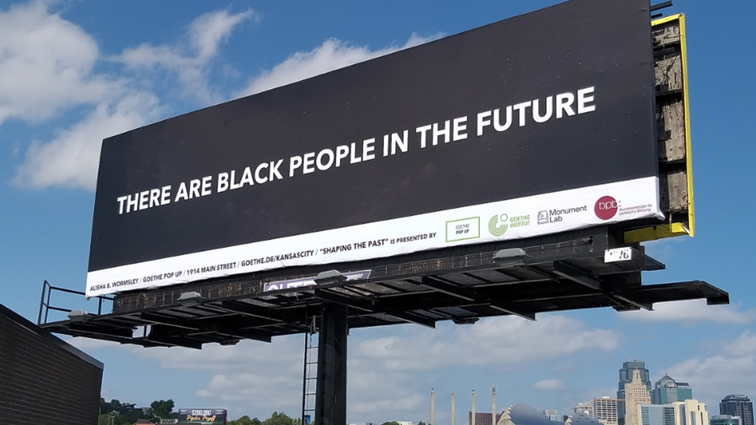 Black billboard with the words "There Are Black People in the Future"